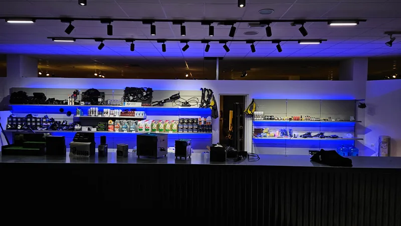 Commercial shelving with blue LED lighting and directional ceiling spotlights
